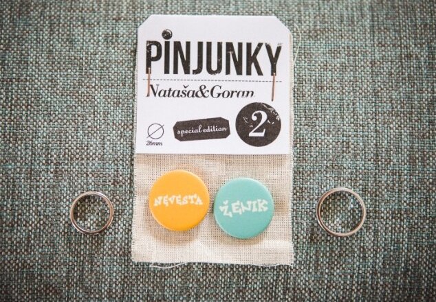 Bedževi prikačeni na goste — detalj